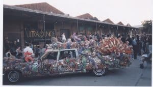 Photograph of an art car sculpture in front of DiverseWorks with a crowd of people at the opening reception of the exhibition Ultralounge.